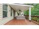 Cozy covered patio featuring comfortable seating, wood floors, and a ceiling fan, ideal for outdoor relaxation at 1980 Marcia Overlook Dr, Cumming, GA 30041