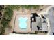 An aerial view of a clover-shaped pool next to a clubhouse and surrounded by trees at 1980 Marcia Overlook Dr, Cumming, GA 30041