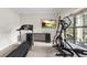 Workout room features an eliptical, treadmill, and view of the green outdoors at 1980 Marcia Overlook Dr, Cumming, GA 30041
