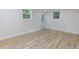 Bright basement room with light colored plank flooring, white walls, and natural light from the windows at 280 E Valley Dr, Marietta, GA 30068