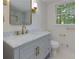 Elegant bathroom with a marble countertop vanity, modern fixtures, and a window at 280 E Valley Dr, Marietta, GA 30068