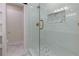 Modern shower with glass doors, white tiles, marble floor, and a decorative shower insert at 280 E Valley Dr, Marietta, GA 30068