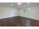 Bedroom with wood floors, white walls, white trim, and a window with view to the outdoors at 280 E Valley Dr, Marietta, GA 30068