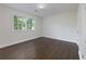 Bright bedroom with dark hardwood floors, white walls, and a window with natural light at 280 E Valley Dr, Marietta, GA 30068