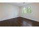 Bright bedroom with dark hardwood floors, white walls, and a window with natural light at 280 E Valley Dr, Marietta, GA 30068