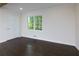Cozy bedroom featuring hardwood floors, a large window, and neutral wall color at 280 E Valley Dr, Marietta, GA 30068