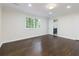 Bright bedroom with dark hardwood floors, white walls, and a window with natural light at 280 E Valley Dr, Marietta, GA 30068