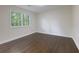 Bedroom with wood floors, white walls, and a window with view to the outdoors at 280 E Valley Dr, Marietta, GA 30068