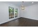Bright dining area features hardwood floors, large window, and stylish light fixture at 280 E Valley Dr, Marietta, GA 30068