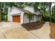 Two-story home with an attached garage, complemented by manicured landscaping and a spacious driveway at 280 E Valley Dr, Marietta, GA 30068