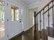 Home foyer featuring hardwood floors, modern staircase, and a storm door at 280 E Valley Dr, Marietta, GA 30068