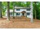 Inviting two-story home with brick facade, complemented by a charming front porch and lush greenery at 280 E Valley Dr, Marietta, GA 30068