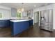 Beautiful kitchen features stainless steel appliances, modern lighting, stylish cabinets, and a large island with a marble countertop at 280 E Valley Dr, Marietta, GA 30068