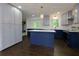 Modern kitchen with two-tone cabinets, quartz countertops, hardwood floors, and stainless appliances at 280 E Valley Dr, Marietta, GA 30068