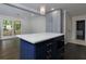 Bright kitchen with a large island, and built in microwave, stylish cabinets, and a view to the living room at 280 E Valley Dr, Marietta, GA 30068