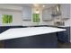 Bright kitchen with a large island, stainless appliances, white countertops, stylish cabinets, and a view of the outdoors at 280 E Valley Dr, Marietta, GA 30068