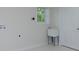 Bright laundry room features utility sink, window, and white walls at 280 E Valley Dr, Marietta, GA 30068