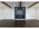 Spacious living room features a modern fireplace, hardwood floors, and exposed wood beams at 280 E Valley Dr, Marietta, GA 30068