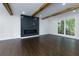 Beautiful living room showcasing hardwood floors, exposed wood beams and stylish fireplace at 280 E Valley Dr, Marietta, GA 30068