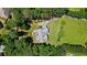 Aerial view shows the home nestled among lush greenery with a well-manicured lawn and a patio perfect for outdoor enjoyment at 380 Russell Rd, Lawrenceville, GA 30043