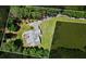 An aerial view of the property featuring a well-manicured lawn surrounded by mature trees, offering privacy and tranquility at 380 Russell Rd, Lawrenceville, GA 30043