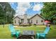 Spacious backyard with lush green grass, mature trees, outdoor seating, and a wooden deck at 380 Russell Rd, Lawrenceville, GA 30043