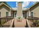 Back view of home with a wooden deck, outdoor furniture, and a table setting at 380 Russell Rd, Lawrenceville, GA 30043