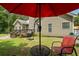 Beautiful backyard featuring lush green grass, a grill, outdoor seating, and a wooden deck at 380 Russell Rd, Lawrenceville, GA 30043