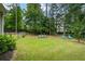 Private backyard with lush green grass and mature trees, perfect for relaxing and outdoor activities at 380 Russell Rd, Lawrenceville, GA 30043