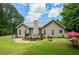 Spacious backyard with a grill, lush grass, mature trees, outdoor seating, and a deck at 380 Russell Rd, Lawrenceville, GA 30043