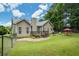 Expansive backyard featuring a deck, outdoor seating, a charcoal grill, and a fenced perimeter at 380 Russell Rd, Lawrenceville, GA 30043