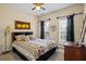 Comfortable bedroom with carpeting, a ceiling fan, and large windows that provide plenty of natural light at 380 Russell Rd, Lawrenceville, GA 30043
