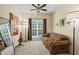 A sunny bedroom with plush carpeting, a ceiling fan, a large window, and ample natural light at 380 Russell Rd, Lawrenceville, GA 30043