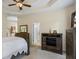 This is a well-lit bedroom with neutral walls, wood furniture, carpet floors, and a ceiling fan at 380 Russell Rd, Lawrenceville, GA 30043