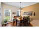 Dining room featuring a wooden table and chairs illuminated by modern chandelier at 380 Russell Rd, Lawrenceville, GA 30043