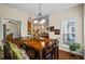 Dining room with hardwood floors, chandelier, and access to living spaces at 380 Russell Rd, Lawrenceville, GA 30043
