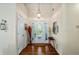 Bright foyer with hardwood floors, decorative lighting and arched front door at 380 Russell Rd, Lawrenceville, GA 30043