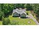 Charming home with a well-maintained lawn, mature trees, and an inviting front porch, offering great curb appeal at 380 Russell Rd, Lawrenceville, GA 30043