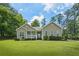 Charming one-story home with a covered front porch, lush lawn, and mature trees at 380 Russell Rd, Lawrenceville, GA 30043