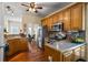 Kitchen with stainless steel appliances, breakfast bar, and oak cabinets at 380 Russell Rd, Lawrenceville, GA 30043