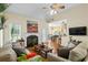 Cozy living room with fireplace, vaulted ceilings, ceiling fan, hardwood floors and lots of natural light at 380 Russell Rd, Lawrenceville, GA 30043