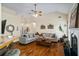 Inviting living room features a fireplace, vaulted ceilings, hardwood floors, and seamlessly connects to the breakfast bar at 380 Russell Rd, Lawrenceville, GA 30043