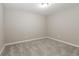 Neutral bedroom with light gray carpet and a bright ceiling light at 6480 Port A Prince Drive Dr, Forest Park, GA 30297