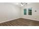 Bedroom featuring two windows, wood flooring, and a modern ceiling fan at 6480 Port A Prince Drive Dr, Forest Park, GA 30297