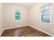 Cozy bedroom with hardwood floors, white trim, and two windows for ample natural light at 6480 Port A Prince Drive Dr, Forest Park, GA 30297