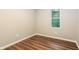 Cozy bedroom with wood floors, white trim, and a window for natural light at 6480 Port A Prince Drive Dr, Forest Park, GA 30297