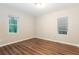 Neutral bedroom offering wood flooring, recessed lighting, and natural light from two windows at 6480 Port A Prince Drive Dr, Forest Park, GA 30297