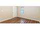 A bedroom features a hardwood floor, an overhead light, a closet and a single window at 6480 Port A Prince Drive Dr, Forest Park, GA 30297