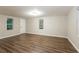 This bedroom features a window and door with hardwood flooring and a neutral color palette at 6480 Port A Prince Drive Dr, Forest Park, GA 30297