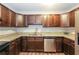 Kitchen with dark wood cabinets, granite countertops, and stainless steel appliances at 6480 Port A Prince Drive Dr, Forest Park, GA 30297